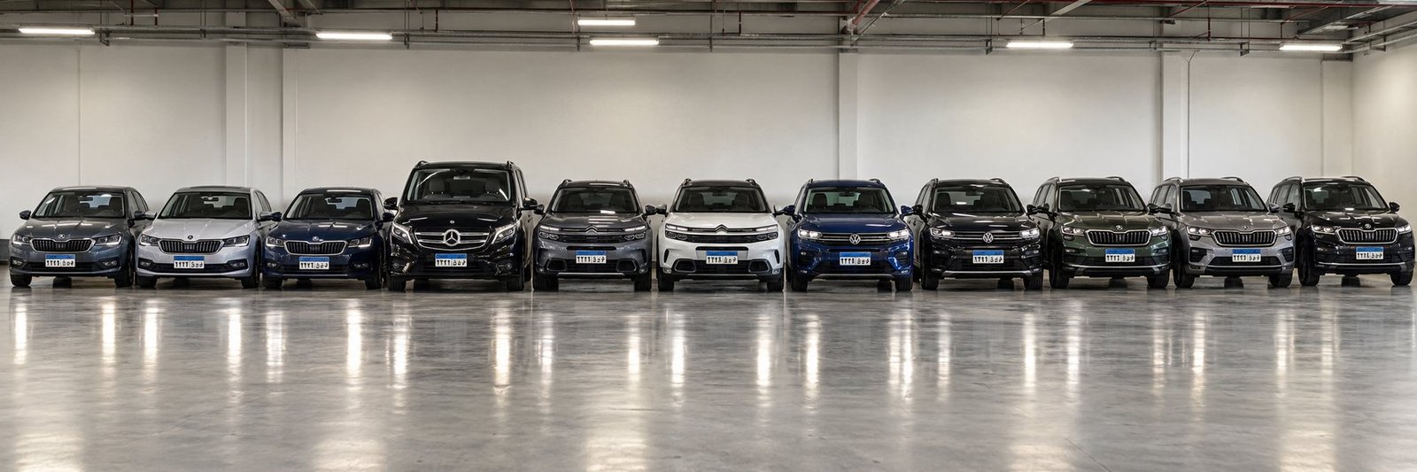 A row of corporate vehicles parked in a covered car park